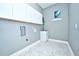 Modern laundry room with sink and white cabinets for extra storage at 10513 Palm Cove Ave, Tampa, FL 33647