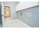Well-lit laundry room with white cabinets and marble floors at 10513 Palm Cove Ave, Tampa, FL 33647