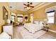 Bright and airy bedroom with tray ceilings, a sitting area, and large windows at 10513 Palm Cove Ave, Tampa, FL 33647