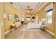 Spacious primary bedroom featuring tray ceilings, wood-look floors, and lots of natural light at 10513 Palm Cove Ave, Tampa, FL 33647