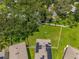 Aerial view of solar panels installed on the roof of the house, surrounded by lush greenery at 10823 Trailing Vine Dr, Tampa, FL 33610