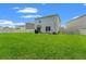Spacious fenced backyard with lush green grass and patio with BBQ grill at 10823 Trailing Vine Dr, Tampa, FL 33610