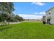 Large, well-maintained backyard with lush lawn, privacy fence, and patio area at 10823 Trailing Vine Dr, Tampa, FL 33610
