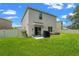 A spacious backyard features a grill and patio area, surrounded by a white fence at 10823 Trailing Vine Dr, Tampa, FL 33610