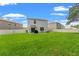 Lush backyard with a privacy fence, patio area and grill at 10823 Trailing Vine Dr, Tampa, FL 33610