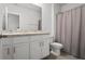 Bathroom with double sink vanity, neutral walls, tile floor, toilet, and shower at 10823 Trailing Vine Dr, Tampa, FL 33610