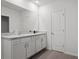 Bathroom featuring double vanity sinks with white cabinets, offering modern functionality at 10823 Trailing Vine Dr, Tampa, FL 33610