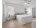 Bright bedroom featuring a ceiling fan and a spacious bed frame with storage drawers at 10823 Trailing Vine Dr, Tampa, FL 33610