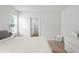 Bright bedroom features neutral tones with a view to a closet, a window, and hardwood flooring at 10823 Trailing Vine Dr, Tampa, FL 33610