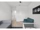 Bright bedroom featuring neutral walls, wood floors, and convertible sofa at 10823 Trailing Vine Dr, Tampa, FL 33610