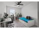 Bedroom featuring a desk and book shelving with a bed, ideal for work and relaxation at 10823 Trailing Vine Dr, Tampa, FL 33610