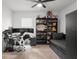 Bedroom with desk and multiple monitors, shelving unit with toys, daybed and ceiling fan at 10823 Trailing Vine Dr, Tampa, FL 33610