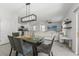Open dining area with modern lighting leading to living room and kitchen at 10823 Trailing Vine Dr, Tampa, FL 33610