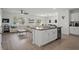Open concept kitchen with island, stainless appliances, and hardwood flooring at 10823 Trailing Vine Dr, Tampa, FL 33610