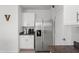 Kitchenette featuring stainless steel refrigerator, cabinets, and granite counters at 10823 Trailing Vine Dr, Tampa, FL 33610