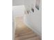 Wooden staircase with white trim and a display of decorative wall art at 10823 Trailing Vine Dr, Tampa, FL 33610
