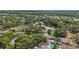Aerial view of neighborhood with mature trees, ponds, and homes with pools at 10902 Bent Tree Pl, Tampa, FL 33618
