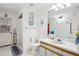 Bright bathroom featuring a white vanity, nautical decor, and a shower with white tile at 10902 Bent Tree Pl, Tampa, FL 33618