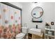 Bathroom with updated vanity, black fixtures, and decorative shower curtain at 10902 Bent Tree Pl, Tampa, FL 33618