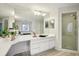 Well-lit bathroom featuring a vanity with double sinks, and walk-in shower at 10902 Bent Tree Pl, Tampa, FL 33618