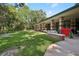 Exterior view of the community clubhouse with picnic tables on the lawn at 10902 Bent Tree Pl, Tampa, FL 33618