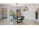 Bright dining room with modern light fixture and chairs, and a built-in display case at 10902 Bent Tree Pl, Tampa, FL 33618