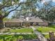 Charming single-story home with mature trees and landscaped front yard at 10902 Bent Tree Pl, Tampa, FL 33618
