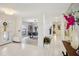 Bright entryway featuring white tile floors, and an open concept living area at 10902 Bent Tree Pl, Tampa, FL 33618