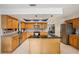 Bright kitchen with granite countertops, stainless appliances, central island, and light wooden cabinetry at 10902 Bent Tree Pl, Tampa, FL 33618