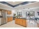 Spacious kitchen featuring granite countertops, stainless appliances, and access to the patio at 10902 Bent Tree Pl, Tampa, FL 33618