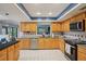 Well-lit kitchen with wooden cabinets, stainless steel appliances, and granite countertops at 10902 Bent Tree Pl, Tampa, FL 33618