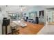 Spacious living room with hardwood floors, a ceiling fan, and large glass doors leading to the patio at 10902 Bent Tree Pl, Tampa, FL 33618
