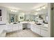 Bright bathroom with double sinks, vanity, mirrors, and a separate shower area at 10902 Bent Tree Pl, Tampa, FL 33618