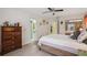 Bedroom featuring a wicker bed frame, dresser, and ensuite bathroom for added convenience at 10902 Bent Tree Pl, Tampa, FL 33618