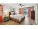 Inviting bedroom with a wicker bed frame and sliding glass doors to pool area at 10902 Bent Tree Pl, Tampa, FL 33618