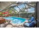 Screened in pool with ample seating and a grill, perfect for outdoor entertaining at 10902 Bent Tree Pl, Tampa, FL 33618
