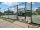 A community tennis court behind a chain link fence at 10902 Bent Tree Pl, Tampa, FL 33618