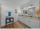 Charming bathroom featuring white shiplap walls, double sinks, and granite countertops at 12492 Eastpointe Dr, Dade City, FL 33525