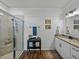 Stylish bathroom with white shiplap walls, granite countertops, and a glass-enclosed shower at 12492 Eastpointe Dr, Dade City, FL 33525