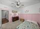 Comfortable bedroom with pink wainscoting, carpet, and a floral mattress on the floor at 12492 Eastpointe Dr, Dade City, FL 33525
