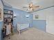 Comfortable Bedroom featuring light blue wainscoting, carpet, and built in shelves at 12492 Eastpointe Dr, Dade City, FL 33525