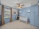 Inviting Bedroom featuring light blue wainscoting, carpet, and built in shelves at 12492 Eastpointe Dr, Dade City, FL 33525