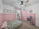 Charming bedroom featuring pink wainscoting, carpet and a floral pattern mattress on the floor at 12492 Eastpointe Dr, Dade City, FL 33525