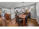 Elegant dining area with a wooden table and modern light fixture, perfect for Gathering meals and entertaining at 12492 Eastpointe Dr, Dade City, FL 33525