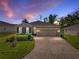 Charming single-story home featuring a brick driveway, stone accents, well-manicured lawn, and pleasant landscaping at 12492 Eastpointe Dr, Dade City, FL 33525