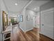 Hallway with wood floors leading to a living area and bedrooms, showcasing a bright and open layout at 12492 Eastpointe Dr, Dade City, FL 33525