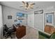 Comfortable home office with a wooden desk and a mounted flatscreen television at 12492 Eastpointe Dr, Dade City, FL 33525