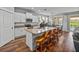 Modern kitchen featuring granite countertops, stainless steel appliances, and a breakfast bar with stylish seating at 12492 Eastpointe Dr, Dade City, FL 33525