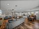 Open-concept living space with wood floors and a modern kitchen, creating an inviting atmosphere for gatherings at 12492 Eastpointe Dr, Dade City, FL 33525