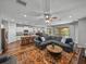 Open-concept living space featuring a large sectional, island kitchen, and access to an outdoor patio at 12492 Eastpointe Dr, Dade City, FL 33525